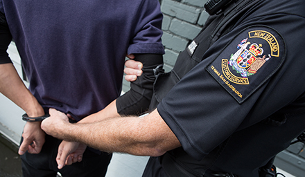 Customs officer arresting individual