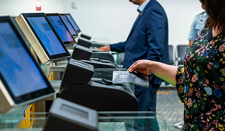 Travellers scan passports at eGates.